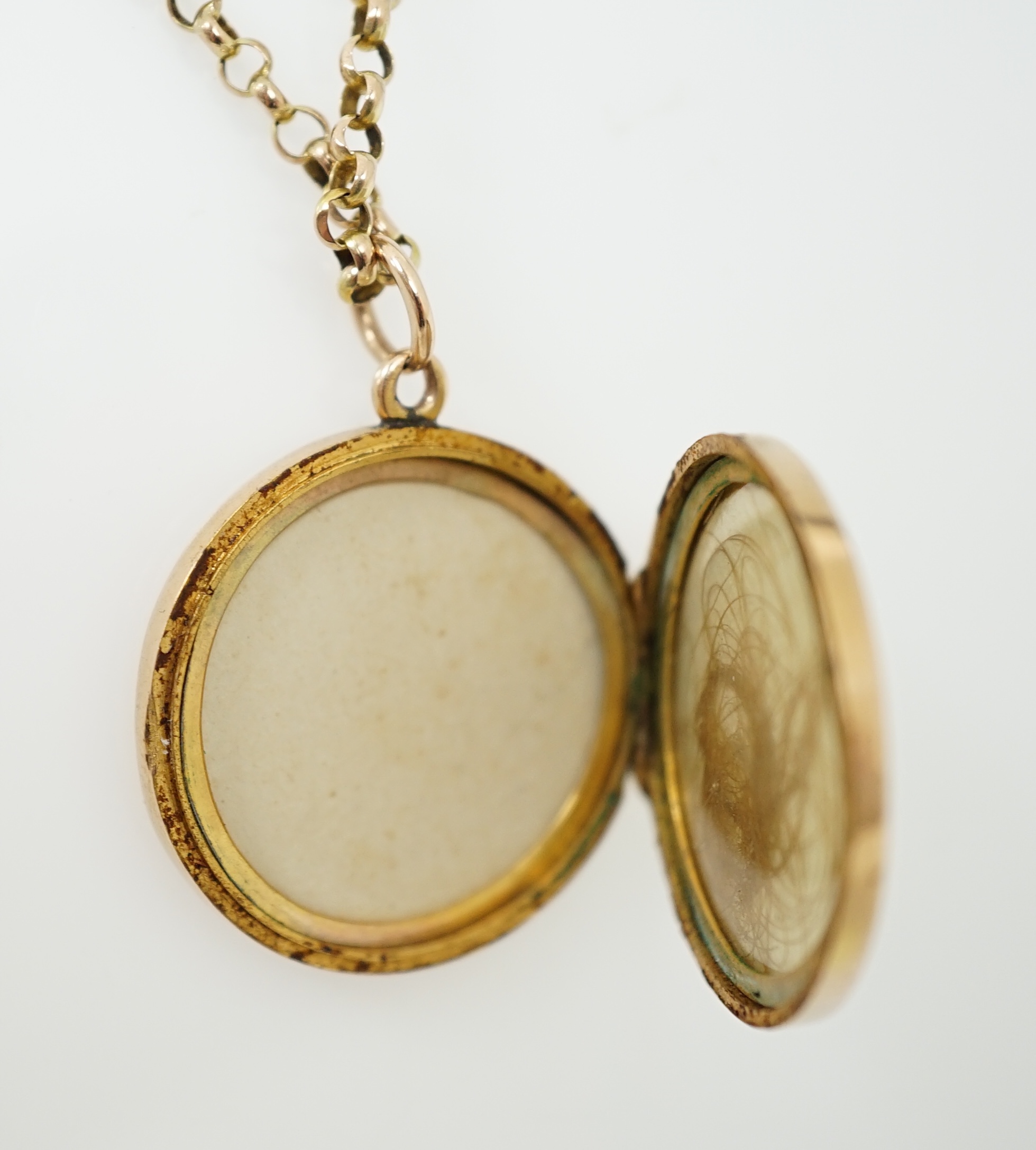 A George V engraved 9ct gold circular locket, diameter 25mm, on a 9ct chain, 45cm